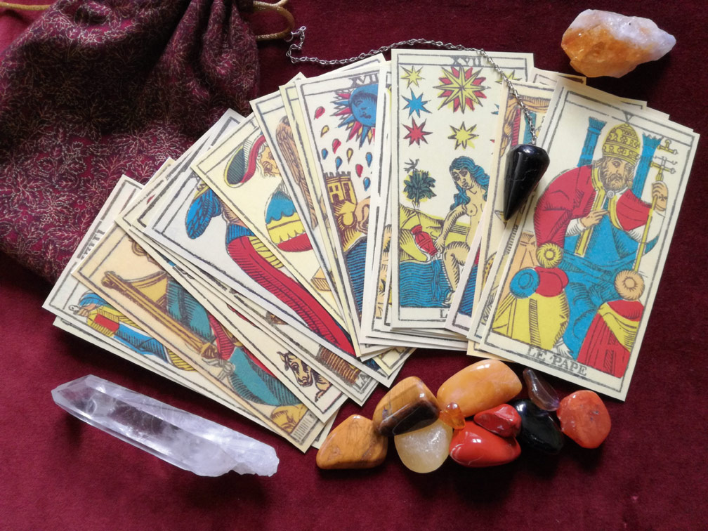 tarot cards, crystals and pendulum; some of the tools of psychic readings